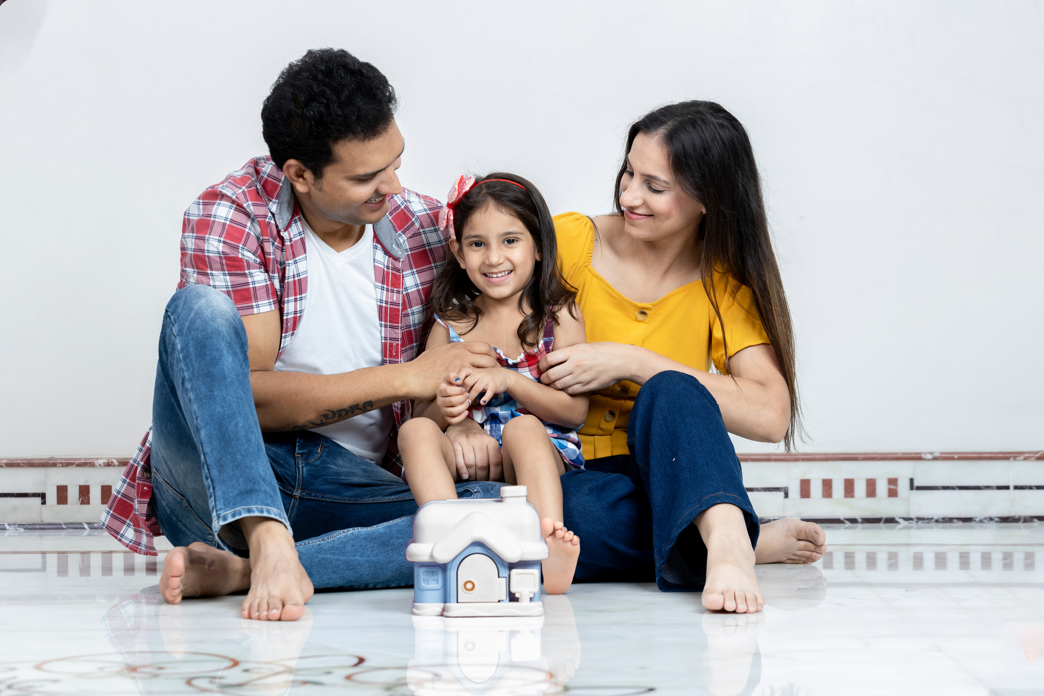 Parents Having Fun With Their Little Daughter At Home,parents relaxing together with mortgage or house insurance